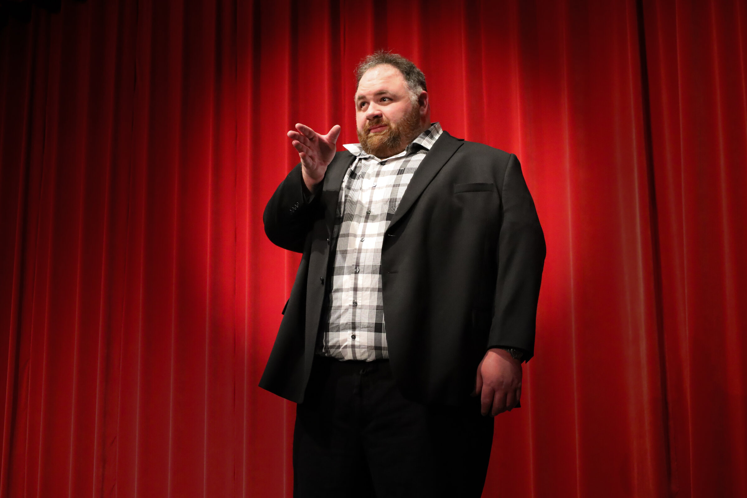 Kevin Lowe speaking energetically on stage