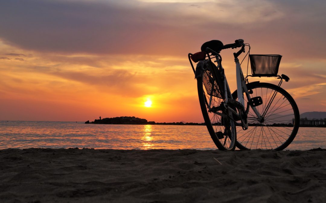 Bike in front of sunset over ocean